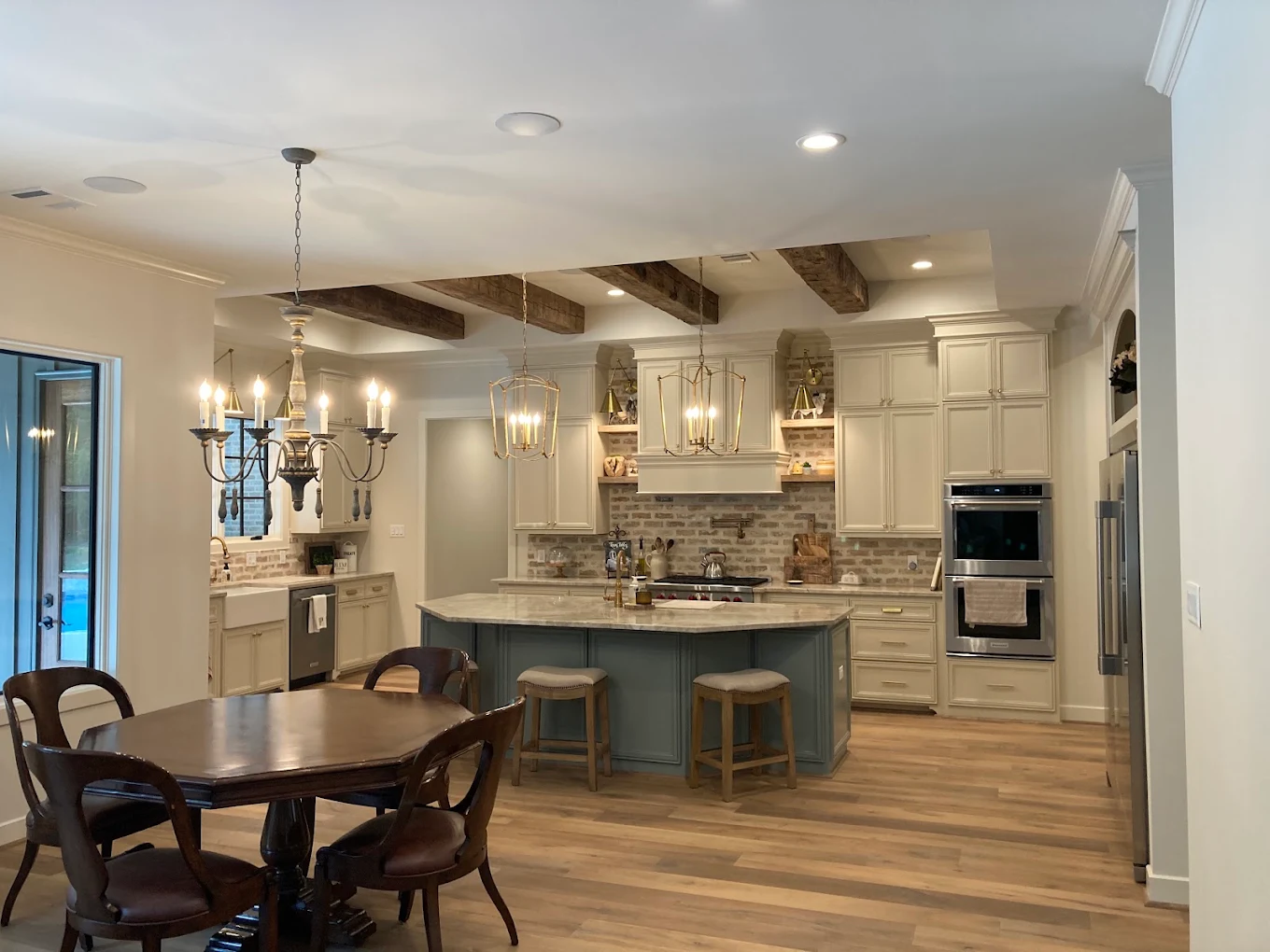 Kitchen with recessed lighting, pendants and a chandelier installed by Lowe Home Electric